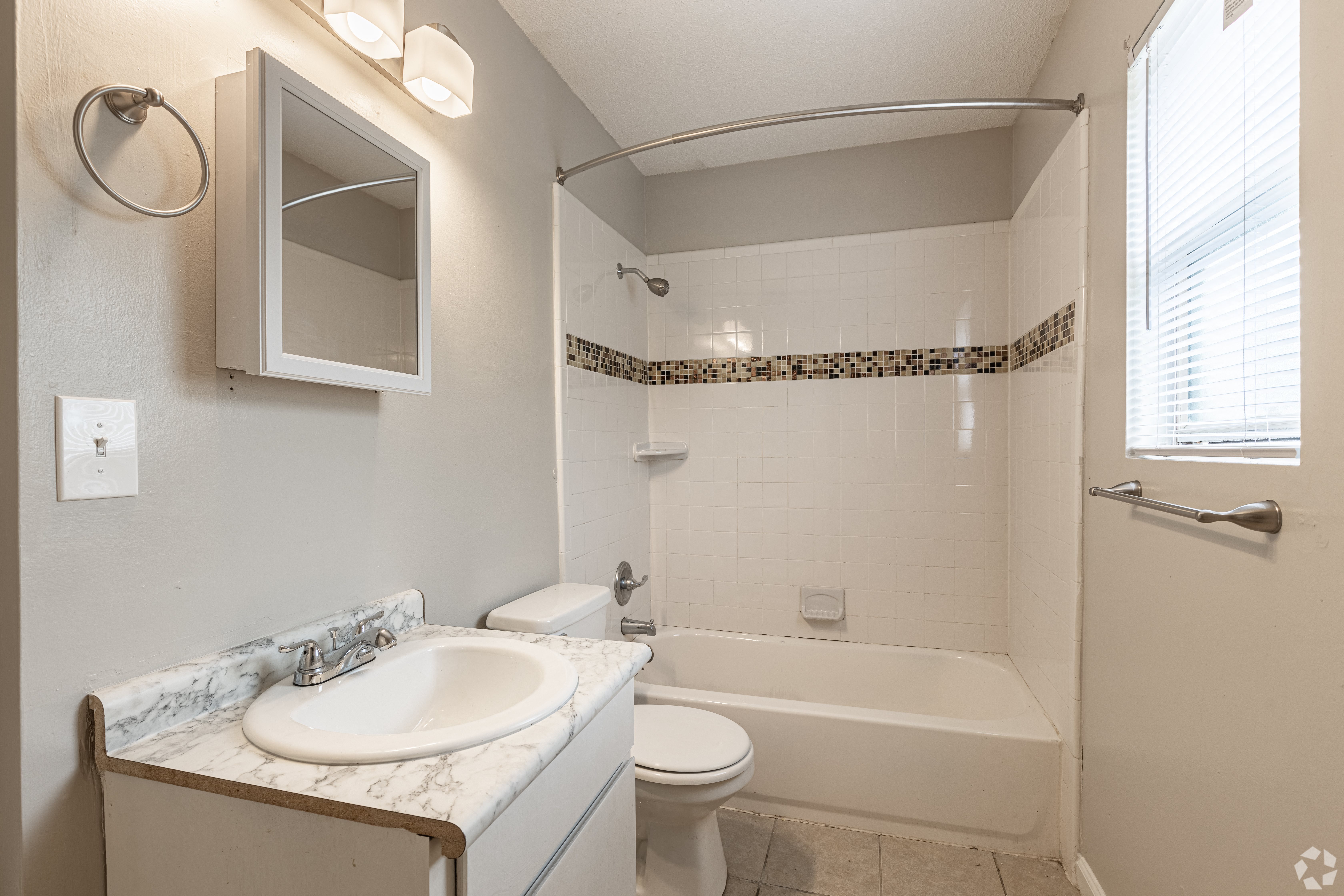 a bathroom with a sink toilet and bathtub